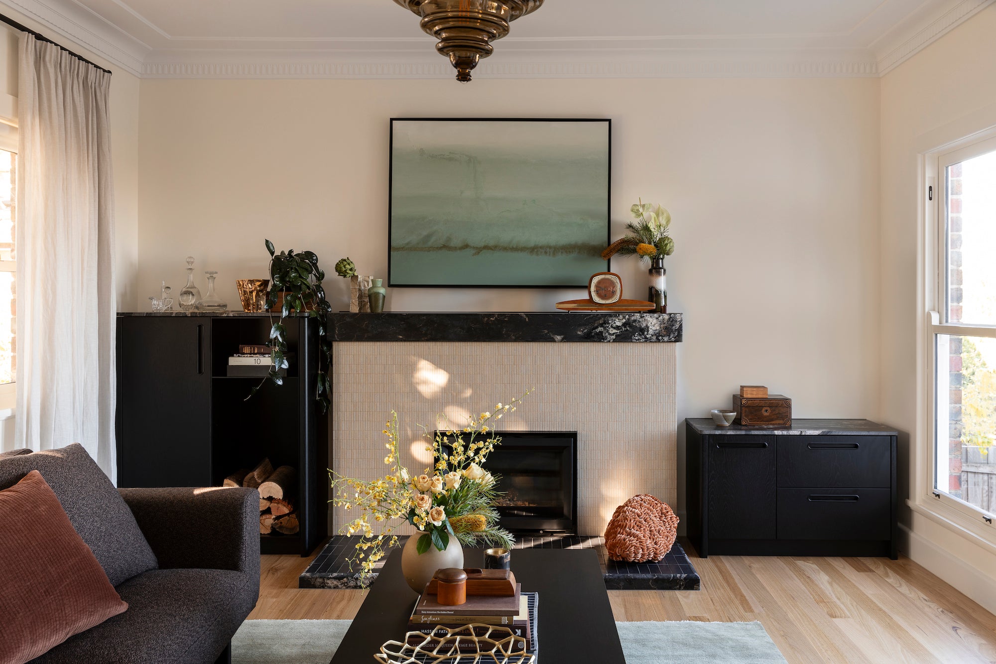 Living room with a fireplace, sofa, and decorative items.